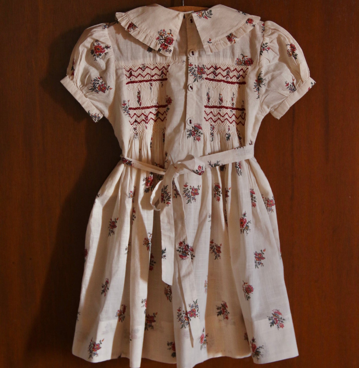 Floral dress with embroidery on a wooden background